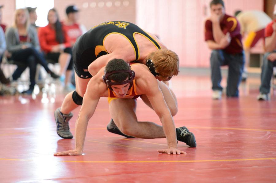 Dylan Nelson, sophomore in industrial engineering, gets ridden by Jon Willians of Wayne State in a 174-pound match at the ISU wrestling club tournament on Saturday, Jan. 19, 2013. at State Gym.
