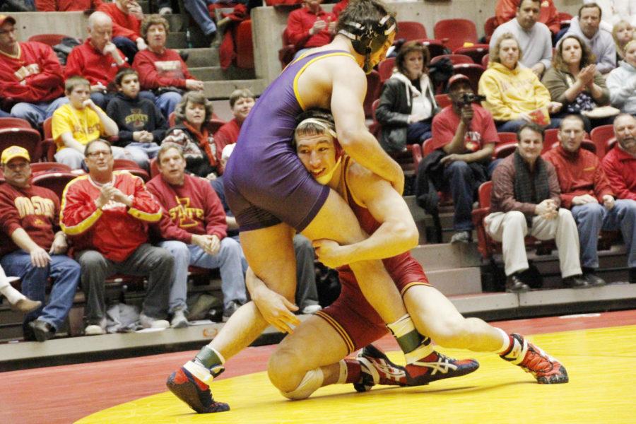 Redshirt freshman Tanner Weatherman takes ahold of fellow redshirt freshman Cody Caldwell of Northern Iowa in the 174-pound match during Beauty and the Beast on Feb. 8 at Hilton Coliseum. Weatherman opened the match with a major decision victory of 13-3 to begin the Cyclones 23-12 win.
