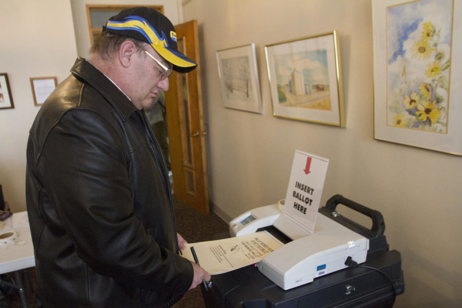 Mark Adkins inserts his ballot into the scan machine Tuesday, Nov. 6, at the Collegiate Presbyterian Church on Sheldon Avenue.
