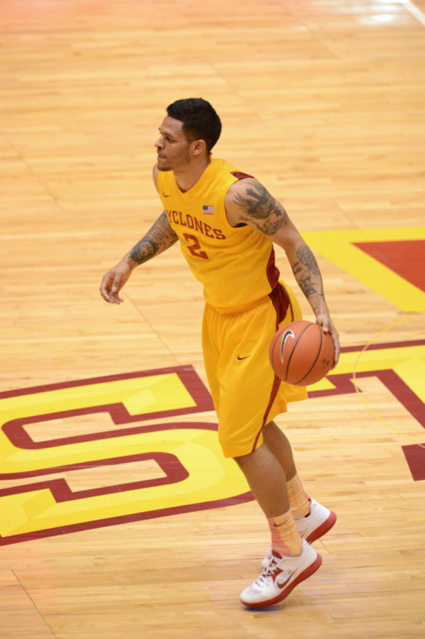 Chris Babb passes the ball in the loss 108-96 against Kansas on Feb. 25 at Hilton Coliseum. Babb had a total of 11 points at the game. 
