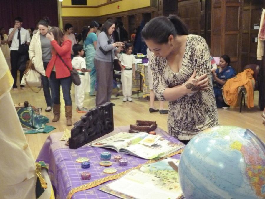 Marli Mesa looks at display of Indian artifacts during Rangoli on Feb. 17 at the Great Hall. Rangoli had various booths and displays showing the culture and heritage of India.
