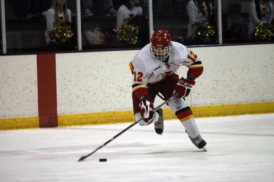 David Elliston, of the D1 ISU hockey team, moves the puck up the ice against the D3 ISU hockey team Saturday, Feb. 23, at the Ames/ISU Ice Arena. The D1 Cyclones defeated the D3 Cyclones 7-1. The two teams faced each other in a two-game series this weekend, as the D1 Cyclones original opponent, North Dakota State, was unable to travel to Ames due to weather earlier in the week.
