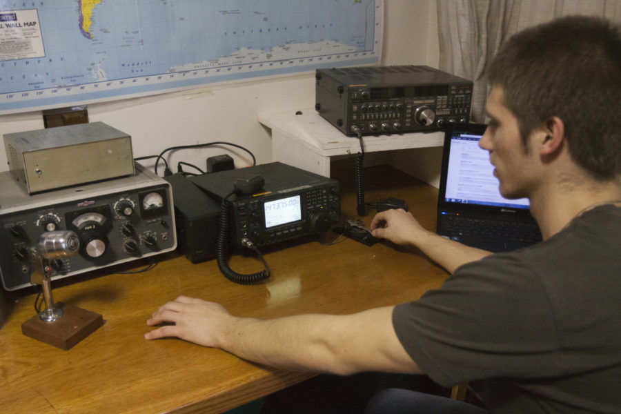 Wyatt Hagen, president of the Cyclone Amateur Radio Club, taps out a morse code signal on an antique radio on Feb. 7. 
