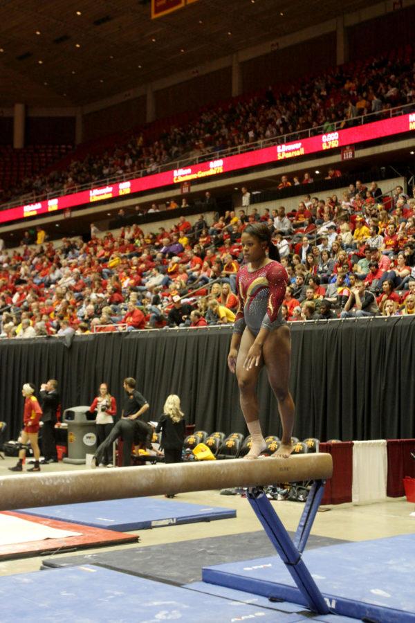 Milan Ivory prepares for her finale of her routine on the balance beam during the Beauty and the Beast gymnastics and wrestling meet  Feb. 8 at Hilton Coliseum.
