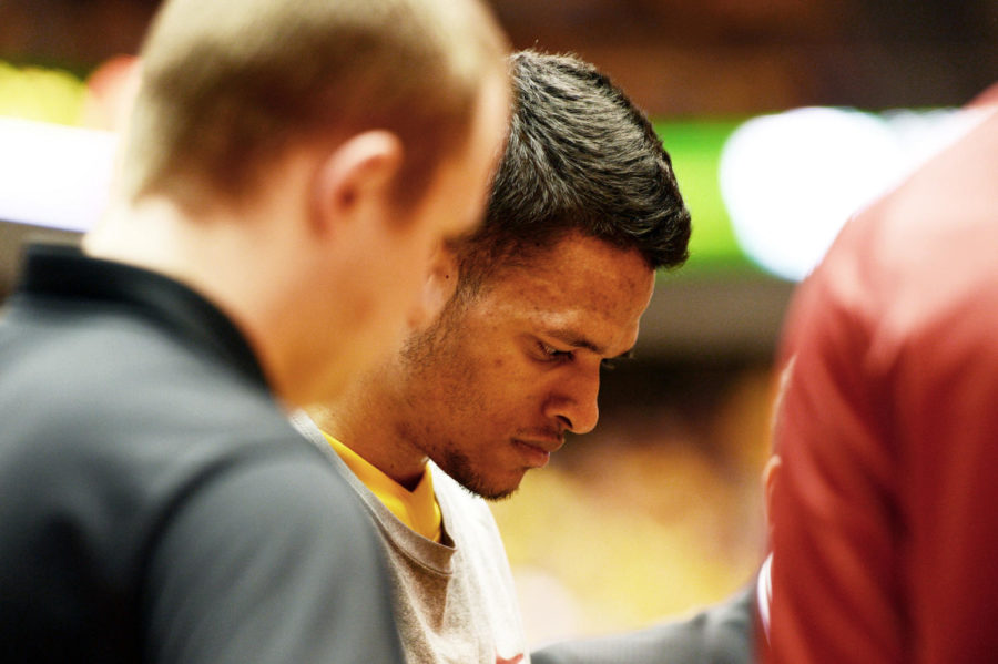 Chris Babb listens to head coach Fred Hoiberg talking during a timeout at second half in the game against Kansas on Feb. 25 at Hilton Coliseum. 

