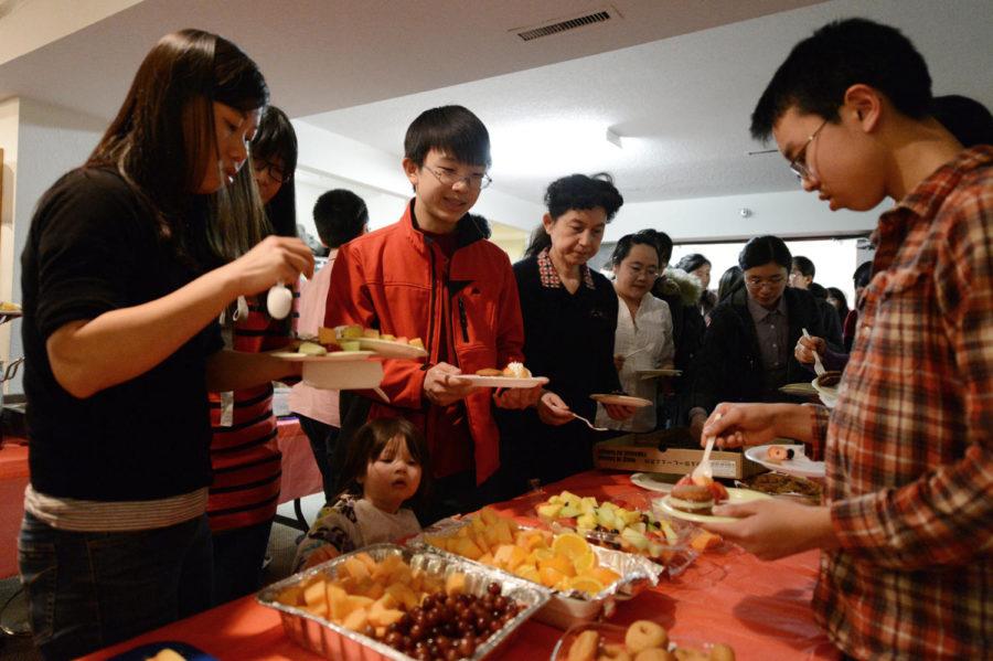 People get desserts during Chinese New Year eve dinner Feb. 9 at Ames Chinese Church. Chinese New Year starts on Feb. 10 and will last 15 days.
