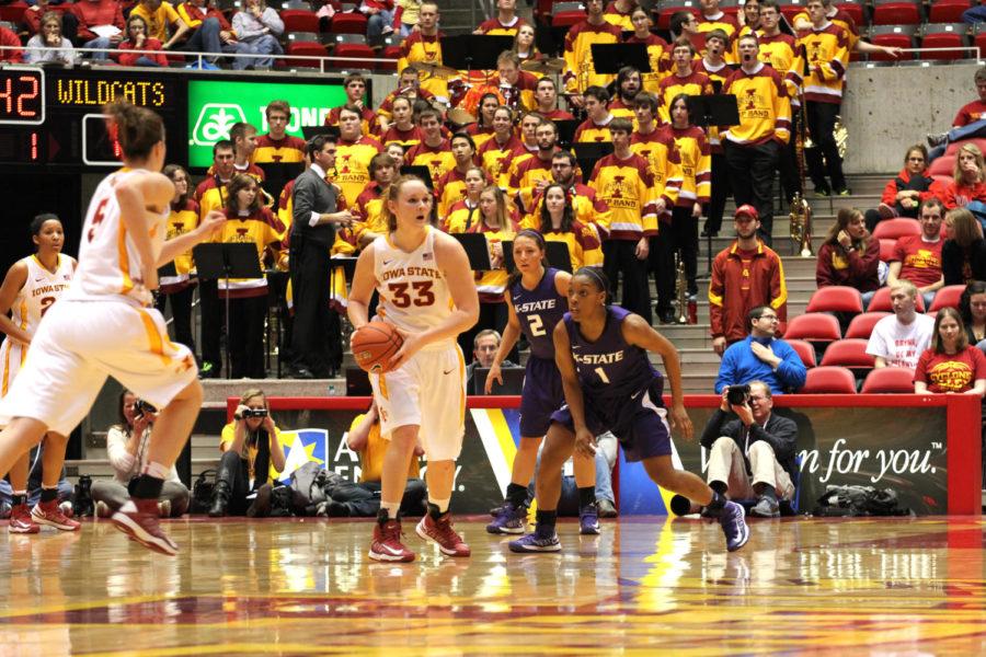 Chelsea Poppens makes a quick pass to her teammate at the 87-71 win against Kansas State on Feb. 9 at Hilton Coliseum.
