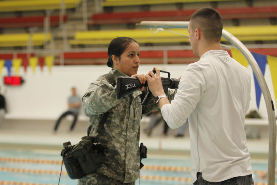 Alexandra Gutierrez, junior in interdisciplinary studies, practices a combat swim with equipment during the ROTC lab on Feb. 18 at Beyer Hall.

