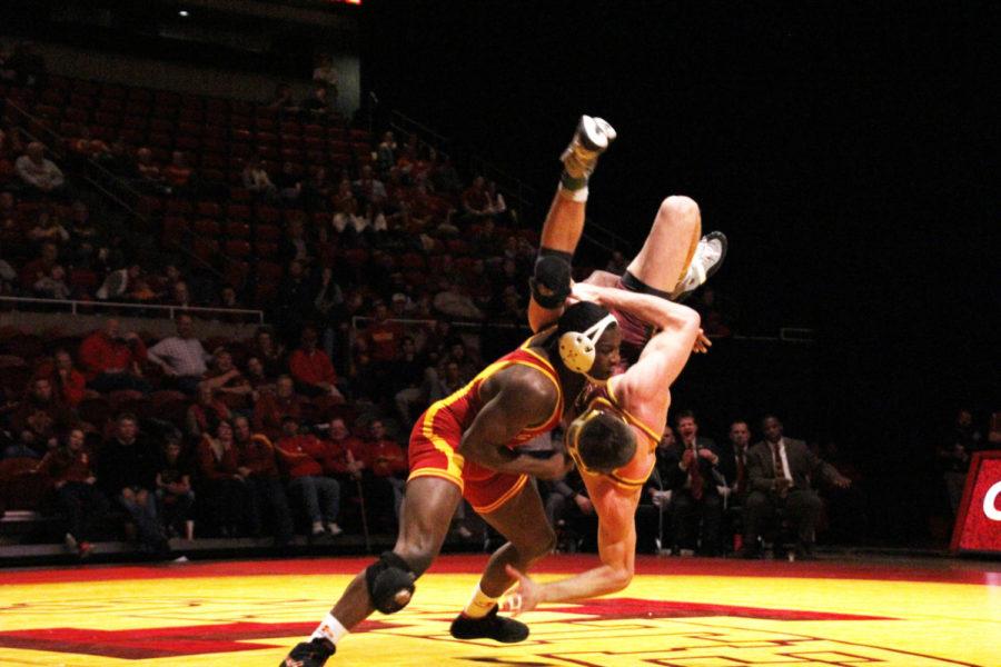 Redshirt sophomore Kyven Gadson throws down Arizona States Jake Meredith, redshirt senior, on Friday, Feb. 1, at Hilton Coliseum. Gadson won his match 9-1 helping the Cyclones clinch a 23-18 victory.

