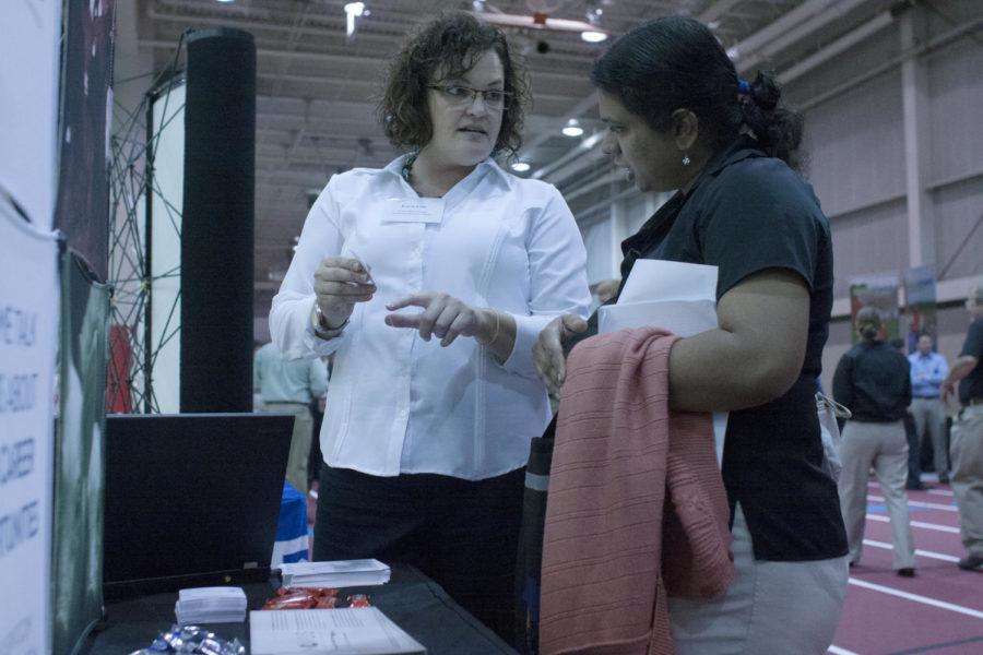 Karen Leche points out information to Dr. Vidya S. Dhanasekaran at the Ag Career Day. The career fair welcomed 208 businesses and organizations, a record number for the Ag Career Day.
