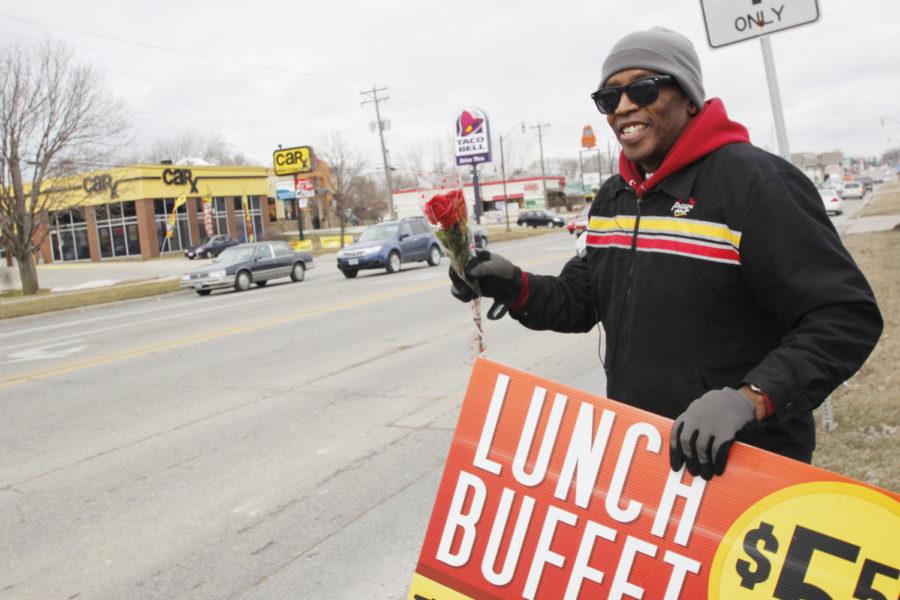 Pizza Hut cook Gary Cornelious dances on the corner of Duff Avenue and 5th Street with a promotional sign on Feb. 14. His sign-twirling abilities have been filmed and used in the training video for Pizza Hut.
