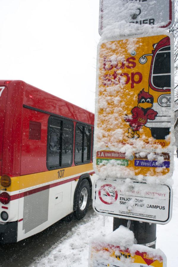 A CyRide bus stop sign is covered with snow during Winter Storm Rocky on Feb. 26.
