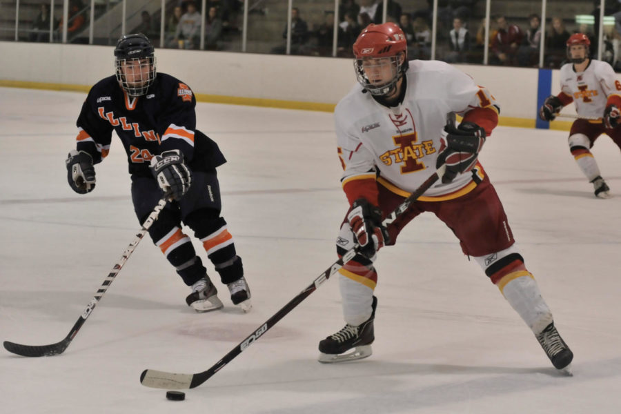 David Kurbatsky attempts to pass the puck to another player
during the game against Illinois as part of the Central States
Collegiate Hockey League on Saturday, Oct. 29, at Ames/ISU Ice
Arena. The Cyclones won 4-3.
