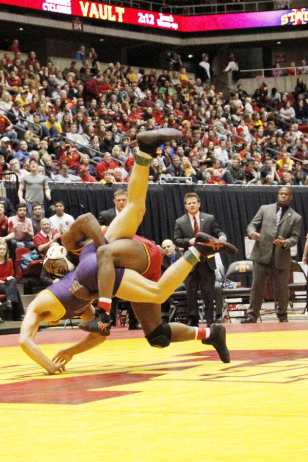 Redshirt sophomore Kyven Gadson throws his opponent Blaize Cabell of Northern Iowa to the mat in the 197-pound match during Beauty and the Beast on Feb. 8 at Hilton Coliseum. Gadson won his match by pinning Cabell after taking a 13-2 lead, and gave the Cyclones six points towards their 23-12 win.
