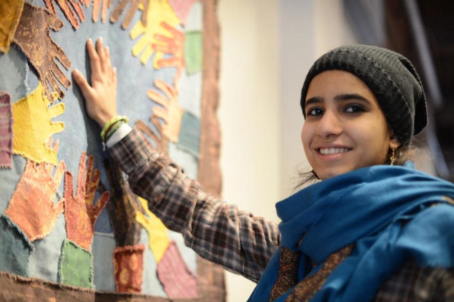 Maisa Al-Wahaibi, freshman in pre-advertising from Oman, places her hand on a bulletin board on Feb. 25 in the multicultural room of the Memorial Union.
