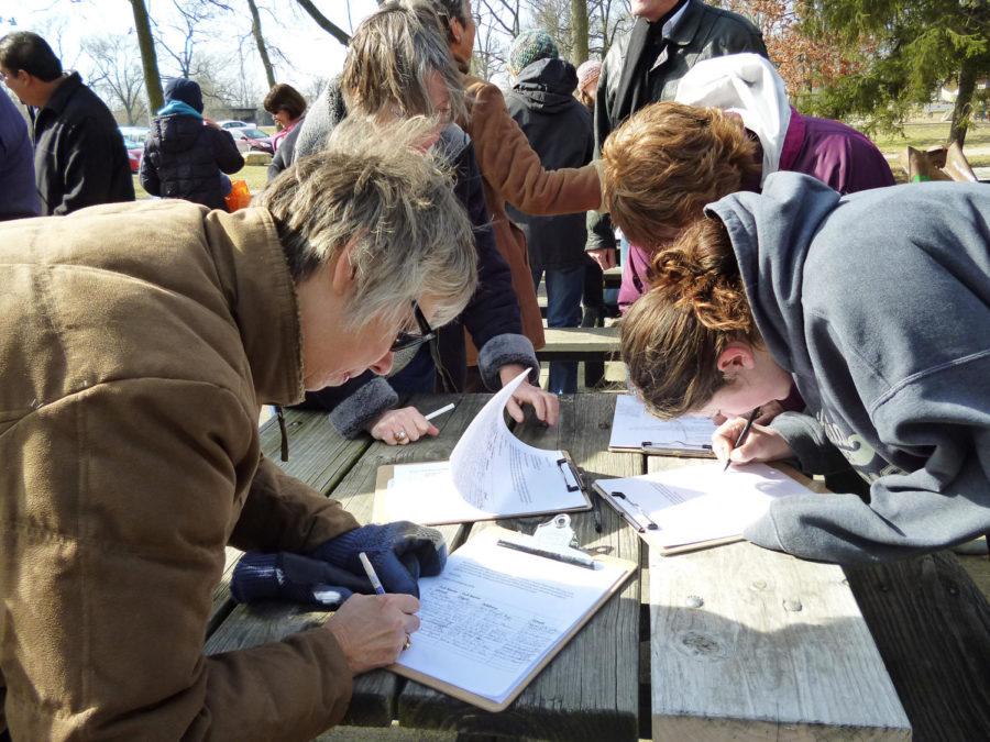 Protestors in Ames sign letters to their representatives opposing the Keystone Pipeline on Sunday, Feb. 17 at Brookside Park in Ames, IA.
