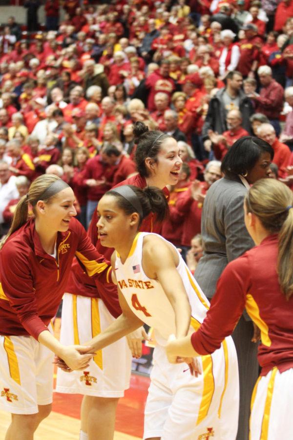 Nikki Moody high fives her teammates during the Cyclone womens basketball game against Kansas on Feb. 27, 2013. The Cyclones won against Kansas University 83-68.
