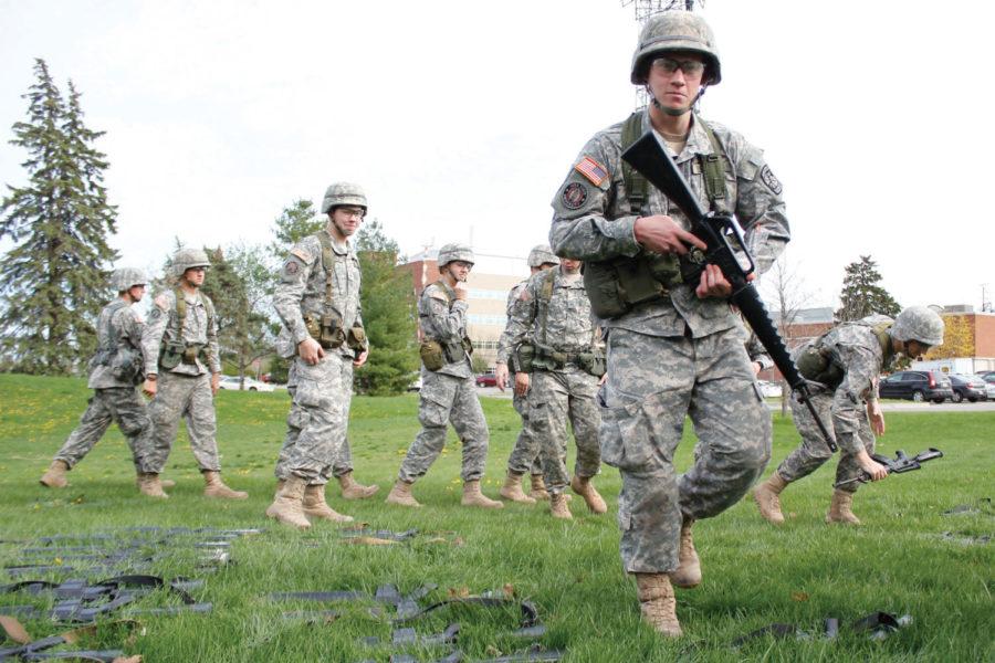 Army ROTC cadets pick up rifles before the commencement of a weekly ROTC lab outside of the Molecular Biology building on Wednesday, April 4, 2012. Among the exercises practiced by the cadets during the class include tactical patrols and weapon handling. 
