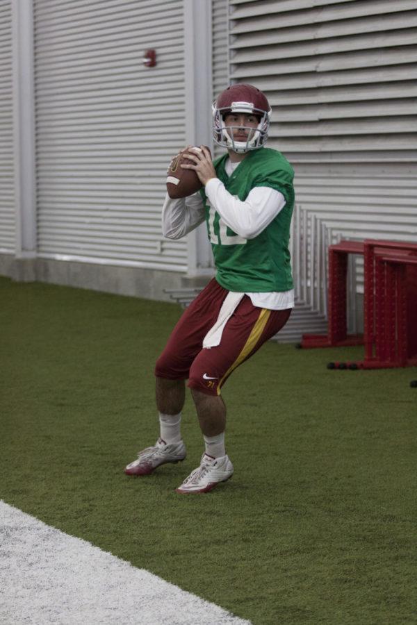 Redshirt sophomore quarterback Sam Richardson warms up his arm during spring football practice at Bergstrom Indoor Training Facility on Tuesday, March 26, 2013.

