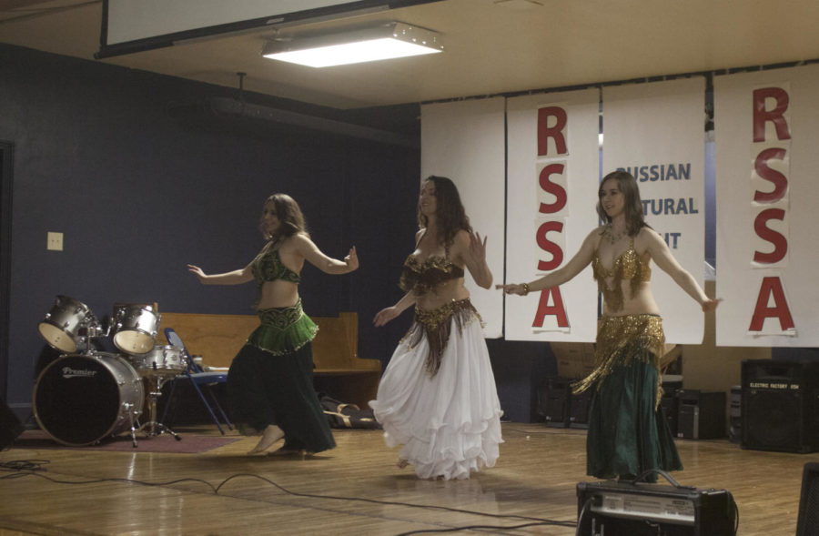 Ladies perform belly dancing on the stage at Russian Cultural Night.
