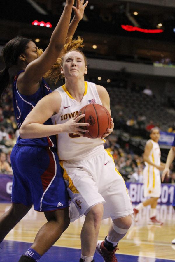 ISU women’s basketball forward Chelsea Poppens closes her eyes as she drives through Kansas defense for a layup during the game against the Kansas Jayhawks on March 9, 2013, at the American Airlines Center in Dallas, Texas. The Cyclones defeated the Jayhawks with a final score of 77-62. Poppens made 10 of her 13 attempted shots in the game.
