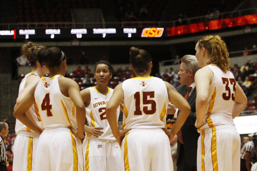 The womens basketball team huddles up as Coach Bill Fennelly talks to them during a time out for the 73-70 win against Oklahoma State on March 4, 2013, at Hilton Coliseum.
