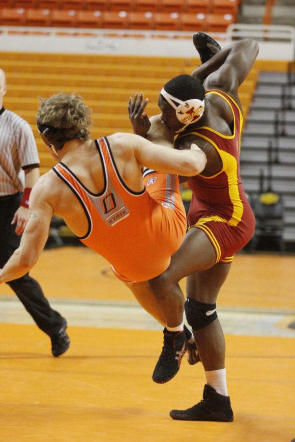 Redshirt sophomore Kyven Gadson kicks No. 11 Blake Rosholts leg from out from under him to send him to the floor at the Big 12 Duals on March 8, 2013, at Gallagher-Iba Arena. No.7 Gadson won his match by a final score of 6-5.
