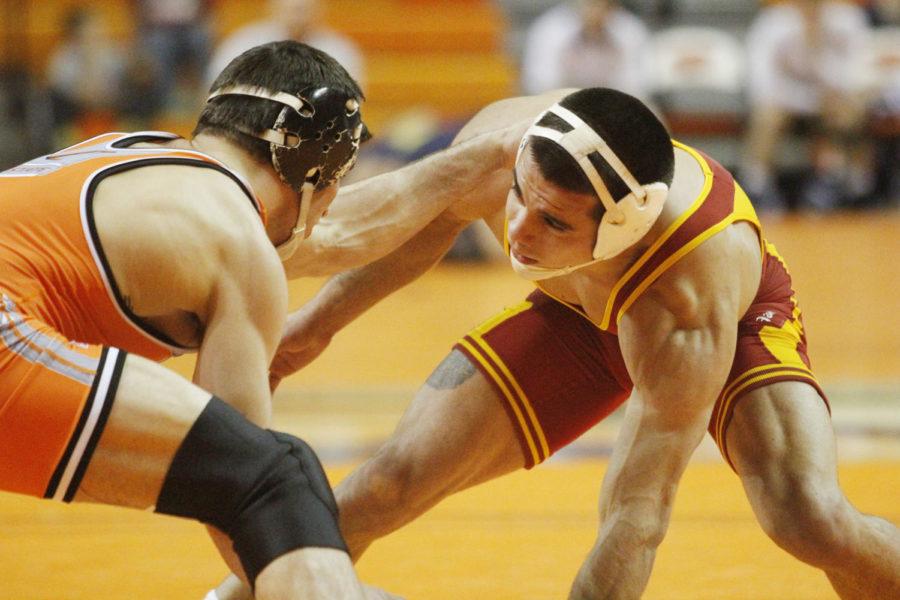 Redshirt sophomore Michael Moreno scraps with No. 3 Tyler Caldwell of Oklahoma State at the Big 12 Duals on March 8, 2013, at Gallagher-Iba Arena. Moreno upset Caldwell 5-2 to score the Cyclones first points in their 27-6 loss.
