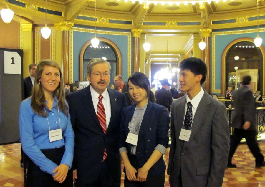 Iowa State students Madeleine Tomka, Hana Yoon and Seth Berbano stand with Gov. Branstad at the Honors Expo at the Capitol in Des Moines, Iowa. 
