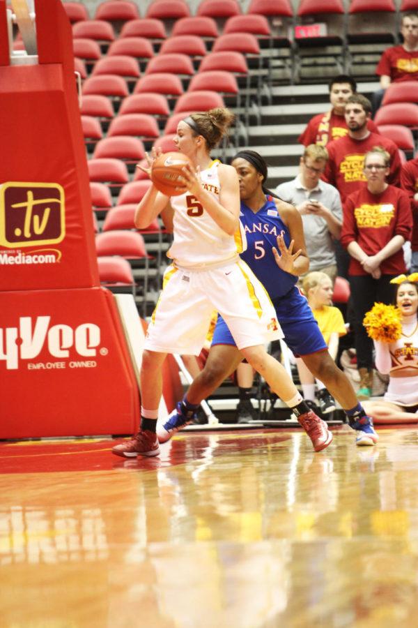 Hallie Christofferson dribbles past her defender during the Cyclone womens basketball vs. Kansas University on Feb. 27, 2013. The final score of the game was 83-68.
