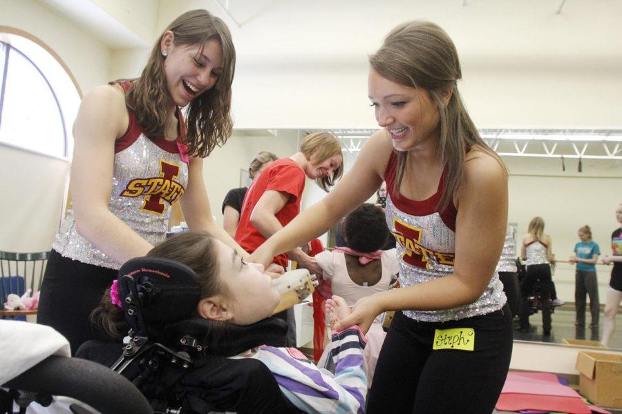 Members of the ISU Dance Team, Stephanie Leeds and Jenna Berg, help Olivia Simanski, 12 of Ankeny, during a dance session for Dance Without Limits on Sunday, March 3, 2013. Dance Without Limits is a program that helps kids with special needs learn to dance despite restraints and Ann Ungs, co-founder and physical therapist for Dance Without Limits, sums it up with a statement: Classes where everyone can dance of all abilities. 
