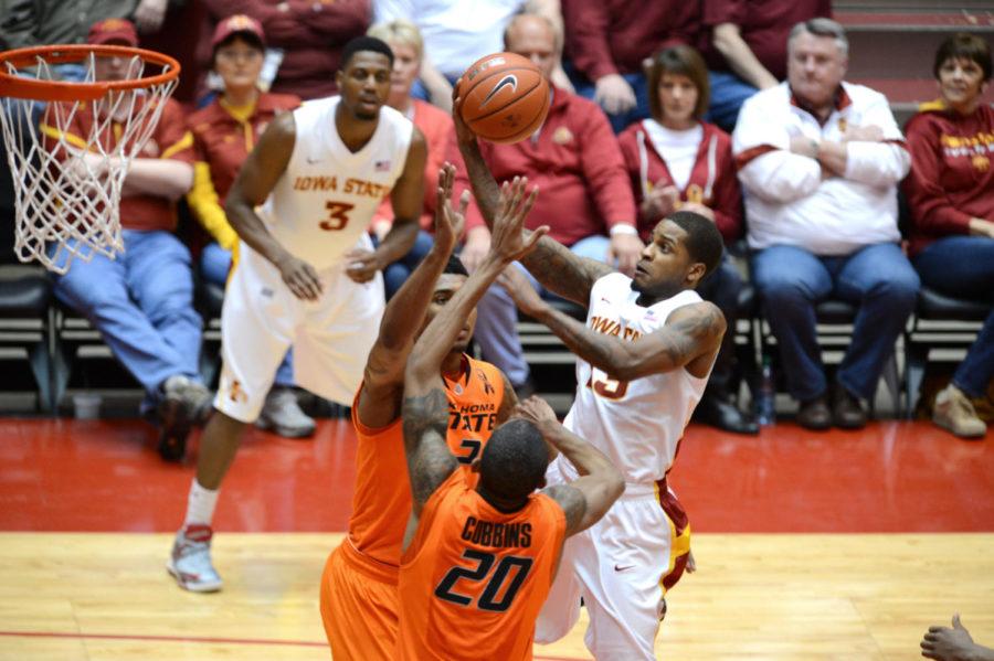 Korie Lucious attempts to shoot the ball in the 87-76 win against Oklahoma State on Wednesday, March 6, 2013, at Hilton Coliseum. Lucious had a total of 11 points in the game. 

