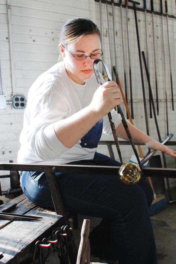 Amanda Hall, graduate student in art and design and member of the ISU Gaffers Guild Club, uses a jack to shape and create a line in a glass structure on Feb. 5 at 1334 Sweeney Hall. A perk of the club is that anyone can join even they are not a student; the only drawback is that there is a waiting list to join. Potential members must take an introductory class and pay fees that range from $90-$120, which covers supplies, except colors, for one semester.
