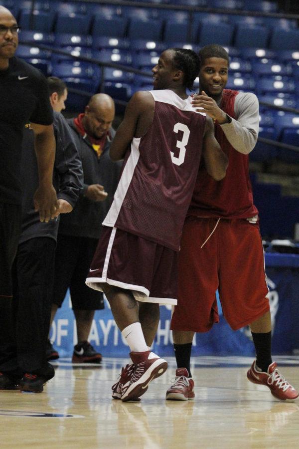 Iowa States Korie Lucious and former teammate, Ionas Tavon Sledge, hug each other at the University of Dayton Arena during the practice sessions on March 21, 2013. 
