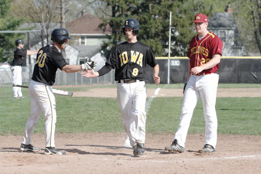 Iowa third baseman Mike Schnur is high-fived by catcher Ian Barber after coming in to score the go-ahead run against Iowa State at the Southwest Athletic Complex on Sunday, April 1. The Cyclones fell to the Hawkeyes 5-3 in the final game of a four-game series, splitting the weekend with Iowa 2-2. 
