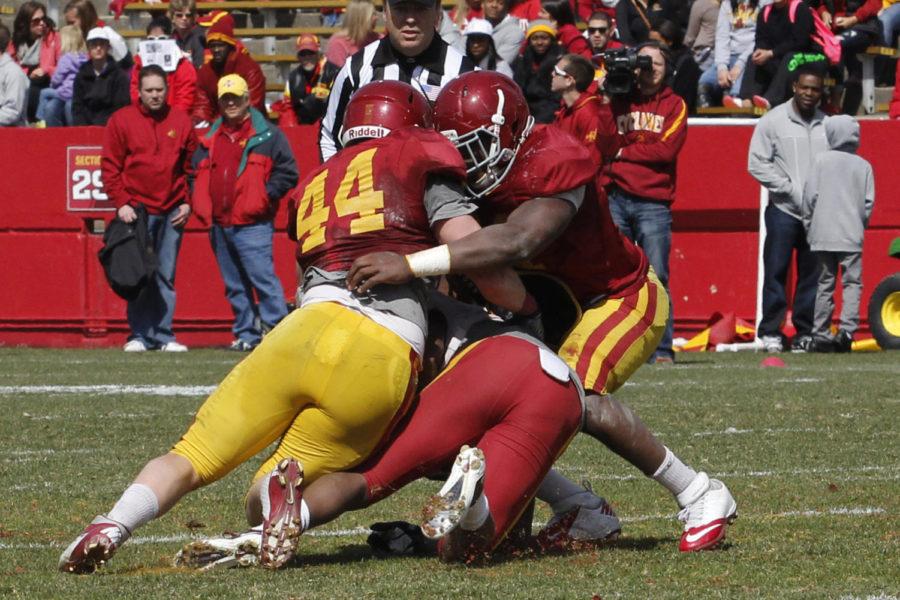 Senior wide receiver Albert Gary gets smashed between freshman linebackers Alton Meeks and Darius White in the spring game on April 20, 2013, at Jack Trice Stadium.
