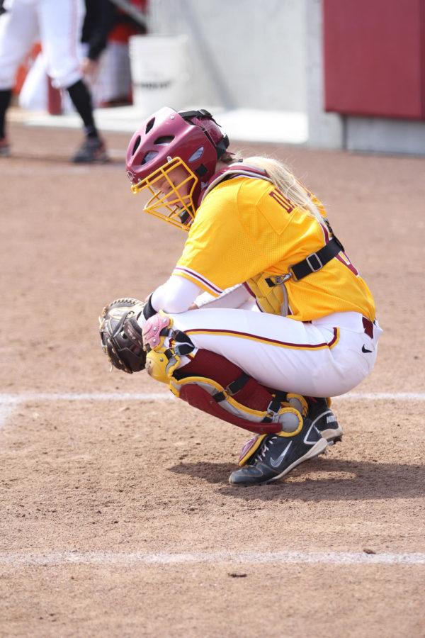 Catcher Sara Davison checks her play sheet after recieving the signal from the coach. Davison went on to play second base when third baseman Tori Torrescano was brought in to pitch at the top of the 6th. The ISU softball team took on Oklahoma State on Sunday, April 7, 2013, wrapping up a weekend-long tournament. The Cyclones won after a game of 6-and-a-half innings with a final score of 9-7.
