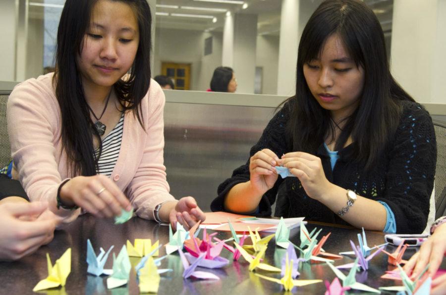 Senior Hannah Giang and sophomore Yiran Xu, members of the ISU Origami Club, fold paper cranes for their clubs current project on Friday, April 26, 2013. The ISU Origami Club is planning to fold 1,000 paper cranes and give them to Mary Greeley Hospital by the end of the year. They chose to do cranes because cranes symbolize hope. They hope that through the project, they are able to give support and hope to the children in hospital. The club was established in October 2012 and currently has 64 members.
