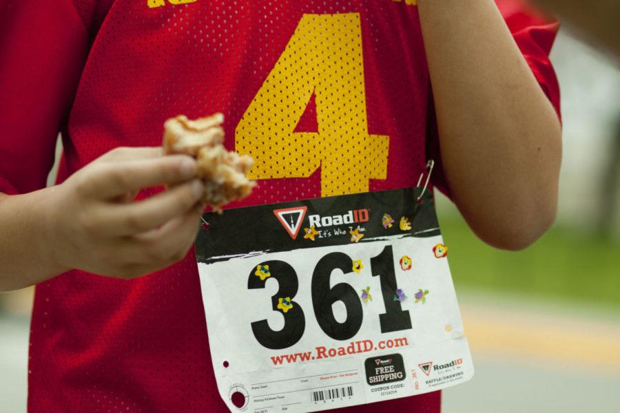 A runner consumes his 12th doughnut during the 5k Doughnut Run on Saturday, April 14, 2012. The race raised money to help send the ISU Triathlon Team to compete at the Collegiate Nationals race in Tuscaloosa, Ala.