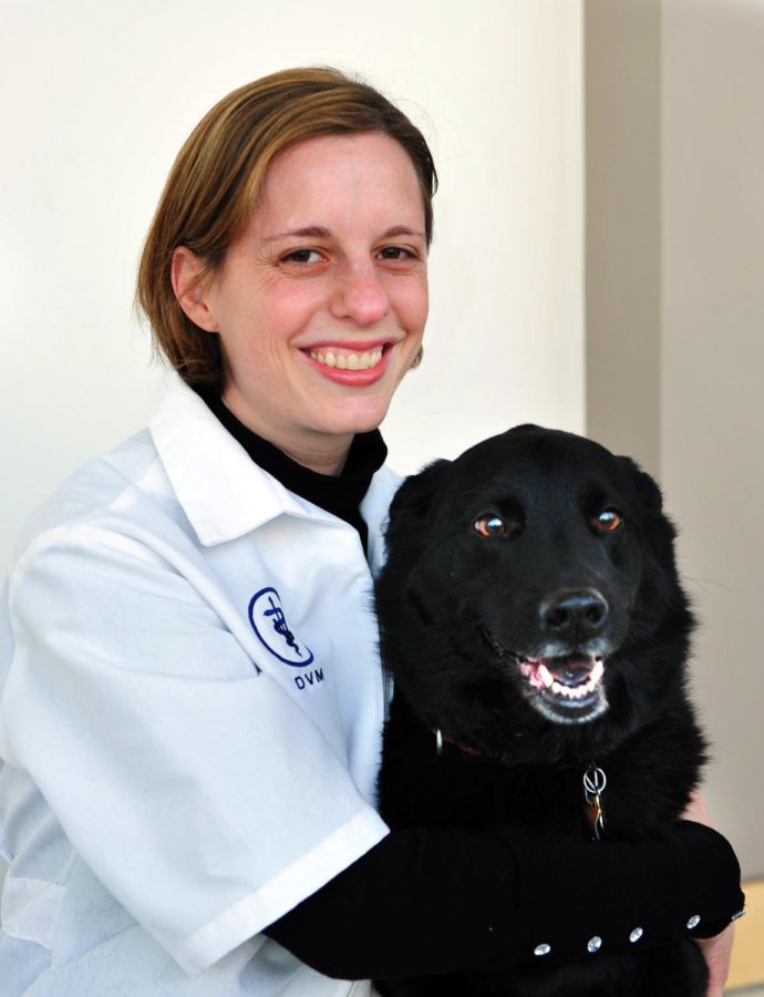 Dr. Dana LeVine poses with her dog Calhoun. LeVine is a new veterinarian for the small animal hospital at the Veterinary Medicine College of Iowa State, and has been doing research in hematology. 
