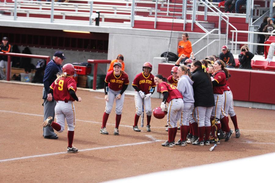The+team+cheers+on+sophomore+Lexi+Slater+as+she+runs+to+home+plate+during+the+game+against%C2%A0Oklahoma+State+on+Saturday%2C+April+6%2C+2013.+The+Cyclones+defeated+the+Cowgirls+8-6.%0A