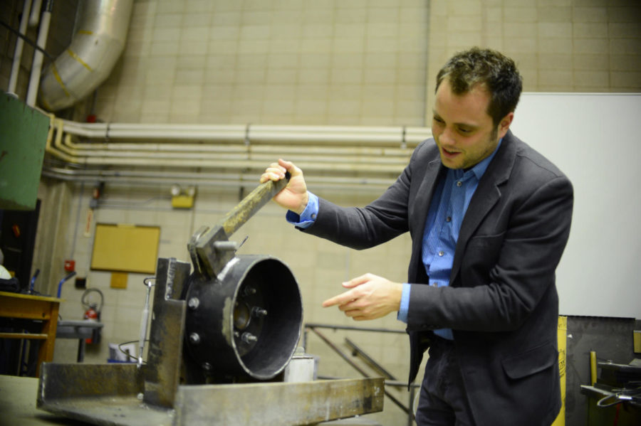 Simon Laflamme, assistant professor of civil, construction and environmental engineering, shows a sample of his project about car brakes, which starts in May 2013.  
