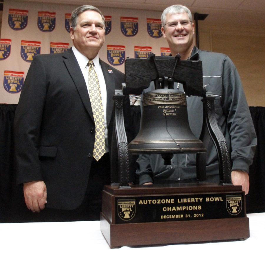 Tulsa coach Bill Bill Blankenship, left, and ISU coach Paul Rhoads pose with the Liberty Bowl trophy on Sunday, Dec. 30, 2012. Iowa State will face the Tulsa in the Liberty Bowl on Dec. 31, 2012, in Memphis, Tenn.
