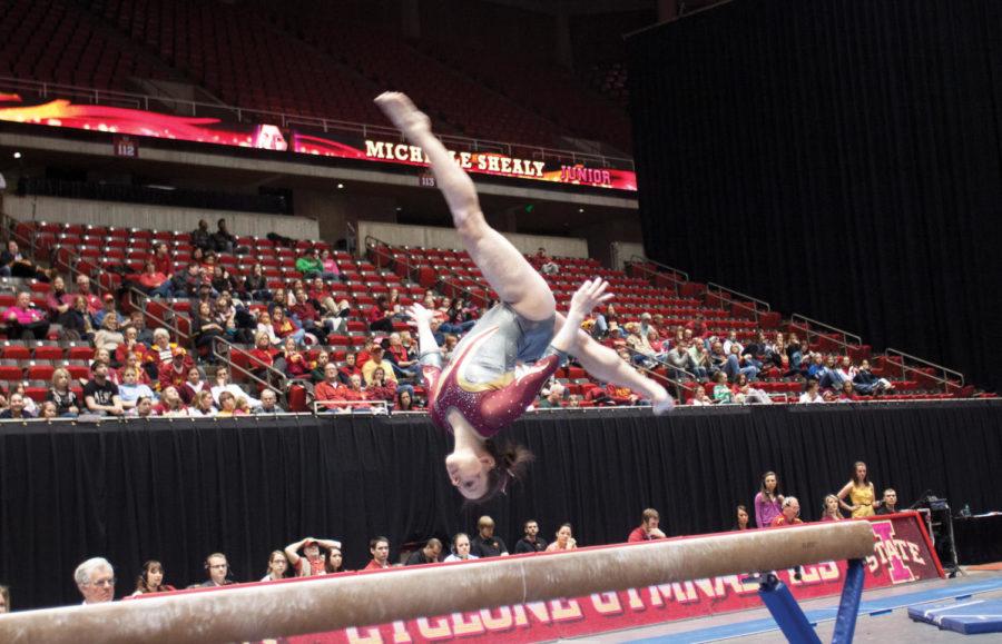 Junior Michelle Shealy does a flip during her performance on the balance beam on Sunday, Feb. 24, 2013, against Minnesota. The judges awarded Shealy a final score of 9.850 out of 10.