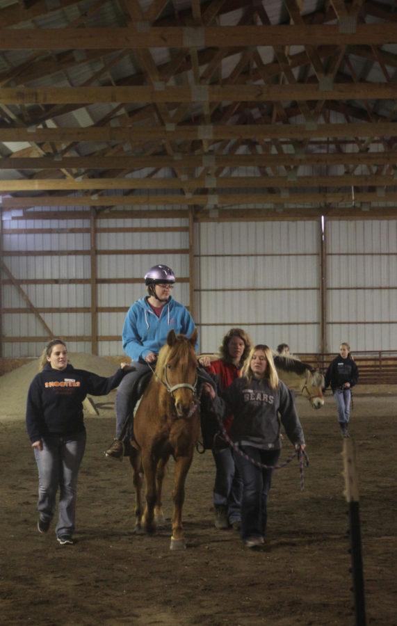 One of the main tasks of volunteers at One Heart Equestrian Therapy Inc. is to walk beside clients as they ride. During Thursday nights training course, this was practiced in the arena.
