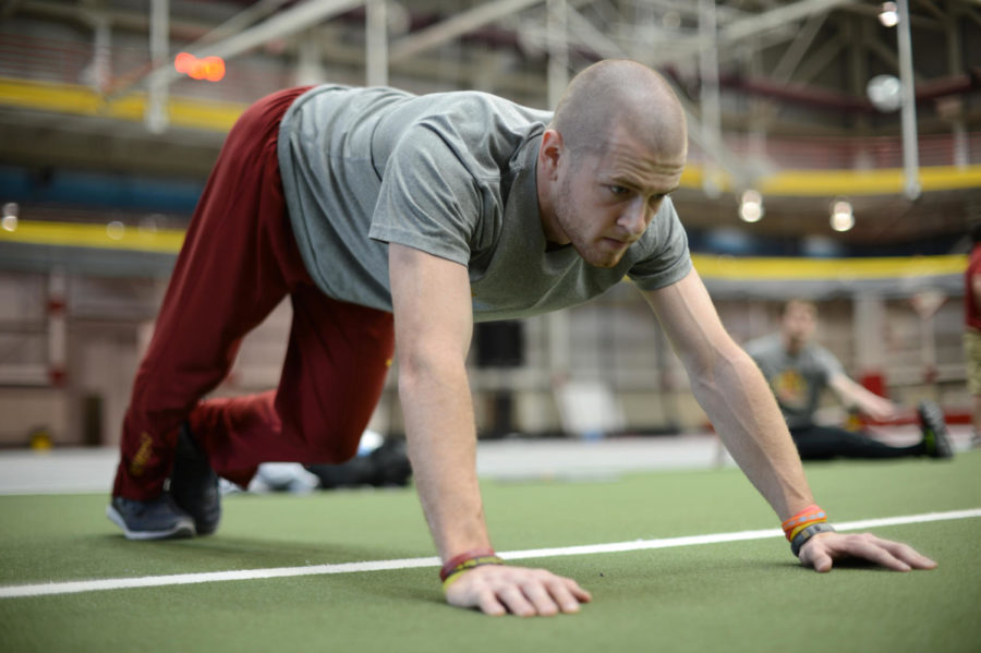 Nick Efkamp stretches before practice on Tuesday, April 2, 2013, at Lied Recreation Center. 
