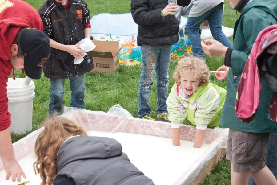 Children play in the goop made by the Material Advantage Club duing Veishea Villeage on Saturday, April 21.

