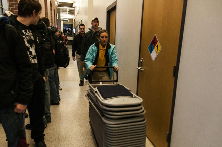 Staff members transport chairs in Kildee Hall to accompany the large number of students eating lunch April 17, 2013. 
