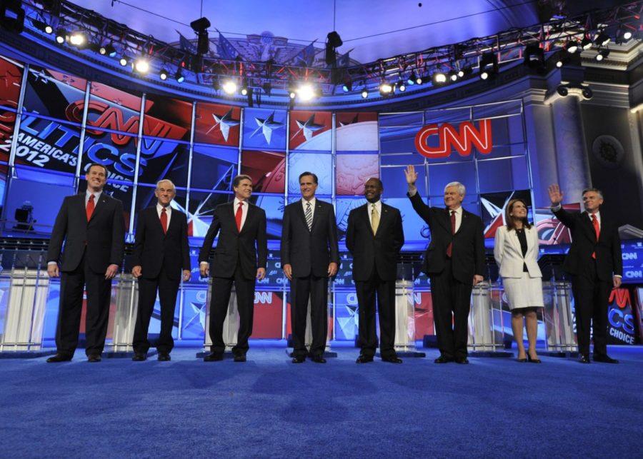 The Republican candidates at the CNN Republican National
Security Debate held at Constitution Hall. Left to right: Former
Pennsylvania Sen. Rick Santorum, Texas Rep. Ron Paul,  Texas Gov.
Rick Perry, former Gov. of Massachusetts Mitt Romney, former CEO of
Godfathers Pizza Herman Cain, former Speaker of the House Newt
Gingrich, Minnesota Rep. Michele Bachmann and former Gov. of
Utah Jon Huntsman. 
