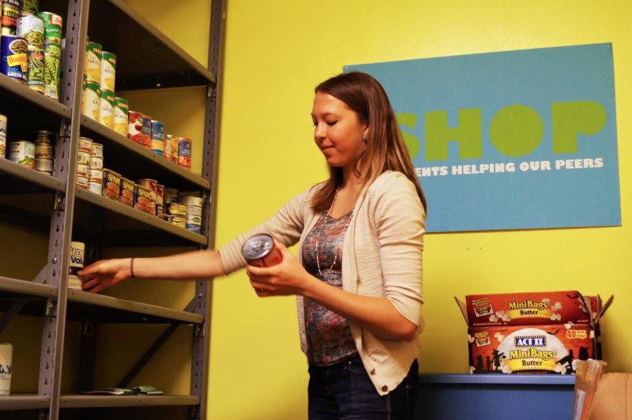 Kirsten Mancosky, sophomore in pre-diet and exercise, puts cans away in the Shop on April 5, 2013. Mancosky helped plan a mobile event of the Shop, which will be taking place at Schilletter-University Village Community Center on April 26. As a result of the event being planned, the Mobile Shop received 500 donations from Greek Week.
